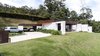 Modern home with Exterior, Stone Siding Material, House Building Type, Flat RoofLine, and Metal Roof Material. Exterior Photo 3 of Entremuros House