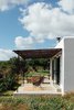 Modern home with Outdoor, Grass, Concrete Patio, Porch, Deck, Front Yard, and Large Patio, Porch, Deck. Owner and architect Jurjen van Hulzen—of the Nieuw and Ibiza Interiors—designed the floor plan of Ibiza Campo Loft, which features a big open space on the south side of the building. This main space is connected to a private terrace with views over the valley. Photo 10 of The Ibiza Campo Loft