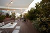 Modern home with Outdoor, Decking Patio, Porch, Deck, Flowers, Trees, Gardens, Raised Planters, Wood Patio, Porch, Deck, Rooftop, Hanging Lighting, and Wire Fences, Wall. Red has the longest wave length of the visible spectrum and can be associated with the longest sound-waves that rather than touching our ears are felt in the torso. Photo 7 of The Seed of Time