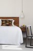 Modern home with Bedroom, Storage, Carpet Floor, Pendant Lighting, Accent Lighting, and Chair. V-grooved timbers lining boards add texture and warmth to bedroom with solid timber bedhead and side table accents of warmth frame the white of the bedding. Photo 11 of Preston 1