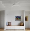 Modern home with Living Room, Bench, Wall Lighting, Storage, and Light Hardwood Floor. A recessed sitting area forms ante spaces to bedrooms behind and provides quiet respite and more display space. Walls lined in groove timber to add character and texture Photo 8 of Preston 1