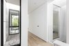Modern home with Chair and Light Hardwood Floor. View from top of stair at second floor towards the rear yard. Interior and exterior lightwells dissolve the relationship between interior and exterior.
Chair: Bonaldo Dragonfly
Photo 14 of Tesseract House