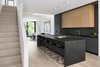 Modern home with Kitchen, Mosaic Tile Backsplashe, Light Hardwood Floor, Undermount Sink, Stone Counter, Track Lighting, Laminate Cabinet, Cooktops, Refrigerator, and Wood Cabinet. View from the front entrance towards the kitchen and living room at the rear of the home. The trees in the rear yard are visible through both the ground and section floor windows. The kitchen island and counters are Brazilian soapstone while the lower millwork cabinets are a super matte black laminate. The upper cabinets are a natural finished rift cut white oak. Beyond and at the centre of the the home, the soffit of the of the second floor landing interlocks with the open to above spaces.
Kitchen Stool: Kristalia BCN Stool Cooktop and downdraft: Bosch Photo 10 of Tesseract House