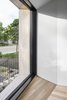 Modern home with Windows and Wood. Detailed view of dining room window and inside-outside relationships defined by form and materiality that are both intimate and expansive. Photo 6 of Tesseract House