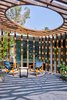 Modern home with Outdoor. The deck with a louvred wooden roof is surrounded by lush foliage and offers an uninterrupted view of the night sky. The master bathroom with monotone concrete grey walls, a step down shower area and ocular sky-roof is an inspiring space that amplifies a sense of seclusion and retreat. Most of the bathrooms in the house feature similar sun-roofs. Photo 9 of Lua - The Moon House by Kriss Real Estate
