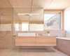 Modern home with Bath Room, Wall Lighting, Wood Counter, Ceramic Tile Floor, Open Shower, Undermount Tub, Vessel Sink, One Piece Toilet, Ceiling Lighting, and Ceramic Tile Wall. Bathroom Photo 4 of Semi detached house on a hillside