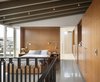 Modern home with Bedroom, Concrete Floor, Track Lighting, Wardrobe, Night Stands, and Bed. An interior palette of cedar, walnut, flagstone, blackened steel and marble stands in contrast to the machine-like character of the exterior of Portage Bay. Site constraints, and the modest needs of a bachelor, led Heliotrope Architects to generate a one-bedroom residence smaller in size and lower in height than the house it replaced. Photo 2 of Portage Bay