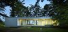 Modern home with Exterior, Flat RoofLine, House Building Type, Cabin Building Type, Glass Siding Material, Metal Siding Material, Beach House Building Type, and Green Roof Material. The floor to ceiling glass sliding doors opens the living spaces to the surrounding waterfront and landscape Photo 2 of North Beach Residence