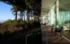 Modern home with Outdoor, Walkways, Decking Patio, Porch, Deck, Trees, Flowers, Gardens, Front Yard, Small Patio, Porch, Deck, Hardscapes, Grass, Wood Patio, Porch, Deck, and Shrubs. The elongated walkway and porch creates outdoor circulation during the summer months Photo 7 of North Beach Residence