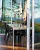 Modern home with Dining Room, Pendant Lighting, Table, Chair, and Medium Hardwood Floor. View into the dining room with the floor to ceiling sliding glass doors. Photo 15 of North Beach Residence