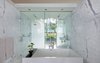 Modern home with Recessed Lighting and Marble Counter. White marble clads the walls and floor of the master bathroom Photo 20 of North Beach Residence