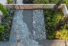 Modern home with Outdoor, Front Yard, Wood Fences, Wall, Trees, Walkways, Stone Patio, Porch, Deck, Gardens, Shrubs, Hardscapes, and Large Patio, Porch, Deck. Landscape Design by Land Morphology Photo 9 of Magnolia Residence