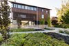 Modern home with Outdoor, Walkways, Flowers, Shrubs, Stone Patio, Porch, Deck, Front Yard, Trees, Hardscapes, Gardens, Large Patio, Porch, Deck, and Wood Fences, Wall. Landscape Design by Land Morphology Photo 12 of Magnolia Residence