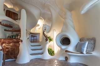 The twist of the fire place matches that of the main staircase and the carved wood is meant to emulate bones sticking out of skin.