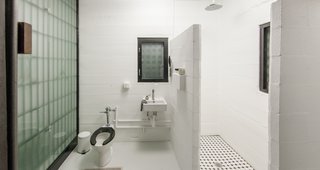 The bathroom is quite spacious, and even features a rain shower. 