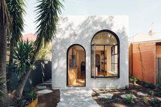 Large windows keep Plaster Fun House bright and breeze-filled. The contrasting stucco and steel frames riff on materials commonly found in older homes in the area.