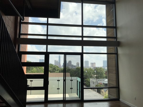One of the loft’s best features is its floor-to-ceiling windows with downtown views—but the original design did little to accentuate them. Chioco and Francis lightened up the rust-orange cement flooring and worked with the couple to get their sense of style and how they lived.