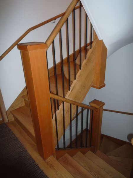 Before: The wooden staircase was cramped, lacked natural light, and created an awkward interior layout. 