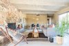 Modern home with Living Room, Bench, Chair, Standard Layout Fireplace, Coffee Tables, Pendant Lighting, Sofa, and Ceiling Lighting. The main hangout space, the living room, is full of fun finds including a Total Design Company rug, local foliage, an HD Buttercup hoop chair and pillows and rugs from The Garage Collective. Photo of Borrego Springs Midcentury