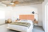 Modern home with Bedroom, Night Stands, Bed, Wall Lighting, Storage, Concrete Floor, and Ceiling Lighting. The master features a Haiti Home headboard, West Elm side tables, TRNK light, Parachute linens, and a Block Shop Textiles throw. Photo 6 of Borrego Springs Midcentury