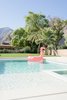 Modern home with Outdoor, Large Patio, Porch, Deck, Trees, Horizontal Fences, Wall, Back Yard, Large Pools, Tubs, Shower, Grass, Raised Planters, and Gardens. "We wanted to have a place to go where we could connect as a family," Lewis says. " I have two children under nine and I want them to play outside and swim." Photo 2 of Borrego Springs Midcentury