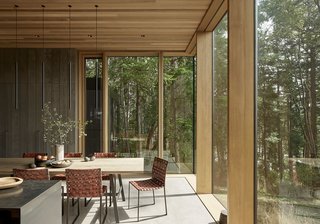 The calm dining room features custom dining table, Davide Groppi MISS LED metal pendant lamps by Omar Carraglia, and the owner’s own dining chairs.