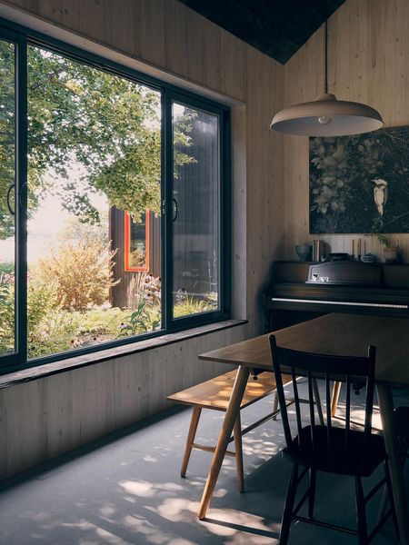 The interiors are honest and simple with pine walls sourced from Eastern Canada. <span style="font-family: Theinhardt, -apple-system, BlinkMacSystemFont, &quot;Segoe UI&quot;, Roboto, Oxygen-Sans, Ubuntu, Cantarell, &quot;Helvetica Neue&quot;, sans-serif;">"We didn't want to have any moldings. The [wood] starts from the concrete floor and around the windows there are more planks,