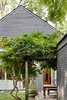 Modern home with Outdoor, Stone Patio, Porch, Deck, Shrubs, Gardens, Grass, Trees, and Back Yard. New Rear Facade from Existing Detached Garage Photo 7 of Albemarle Addition / Renovation
