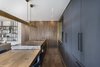 Modern home with Kitchen, Colorful Cabinet, Marble Counter, Wood Counter, Medium Hardwood Floor, Pendant Lighting, and Metal Backsplashe. The creation of new ways to use natural materials, reproducing the effects of layering found in nature. Photo 3 of The Layers apartment