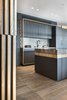 Modern home with Kitchen, Wood Cabinet, Light Hardwood Floor, Pendant Lighting, Marble Counter, Marble Backsplashe, and Colorful Cabinet. Layers... Photo 7 of The Layers apartment