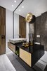 The three main materials in this apartment form a cascade of metals, woods and marbles combined as a range of materials, displayed as surfaces and as significant masses with different finishes. Photo 15 of The Layers apartment modern home