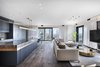 Modern home with Living Room, Medium Hardwood Floor, Ceiling Lighting, Pendant Lighting, and Coffee Tables. Maximum openness inside and in terms of its connections with the outside. Photo 17 of The Layers apartment