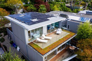 The solar photovoltaic rooftop panels draw 12 kilowatts of electricity. The prefabricated cross-laminated timber structure is insulated by 17-inch walls, and the deck outside the master bedroom is bordered with sedum.