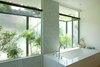 The tub sits sits in the ‘wet zone’ of marble, next to the garden. Open the window and you’re sitting almost outside! Photo 12 of Los Feliz Residence modern home