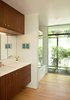 Modern home with Drop In Sink. The children’s bathroom with it’s full-height window to the garden. The shower/tub is defined by mosaic marble walls, and the vanity is a floating walnut cabinet with a white Caesarstone top. Photo 13 of Los Feliz Residence