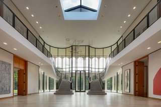 The atrium features steel and bronze balustrades.