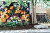 Modern home with Outdoor, Concrete Fences, Wall, Walkways, Gardens, Landscape Lighting, Back Yard, Trees, Shrubs, and Stone Patio, Porch, Deck. Backyard mural at The Sursy #WeeHouse, next to two cruiser bikes ready for guests!
Meet The Makers:
.MURAL / Kirileigh Jones (Denver, CO)
.HOMEOWNER, ARTIST and ARCHITECT / Nicole Delmage (Denver, CO) Photo 6 of The Sursy WeeHouse