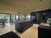 Modern home with Kitchen, Light Hardwood Floor, and Pendant Lighting. Island kitchen is the heart of the villa. Photo 5 of Villa Kivi