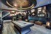 The front of the oversized bar is elevated to allow for a custom built-in vessel and drain, perfect for showcasing celebratory champagne or floral displays. The contrast between white and black granite brings an extravagant visual effect, while adding symmetry. The bar is inlaced with gold gilded glass insets and LED accent lighting, which adds warmth and ambient lighting creating a seductive feeling. Photo 4 of Opulent Estate in Vancouver’s Premier Neighbourhood modern home