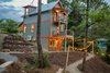 Modern home with Exterior, Shed RoofLine, Tiny Home Building Type, Wood Siding Material, Concrete Siding Material, Stucco Siding Material, Metal Roof Material, Gable RoofLine, and Metal Siding Material. Back of house Photo 2 of Mountain Bikers Tiny House Getaway