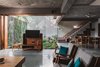 Modern home with Living Room, End Tables, Ceiling Lighting, and Chair. Connection of living room, dining area and courtyard Photo of Jungalow
