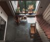 Modern home with Living Room, Chair, End Tables, Ceiling Lighting, and Coffee Tables. View of double heighted family room Photo 16 of Jungalow