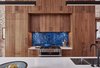 Modern home with Kitchen, Light Hardwood Floor, Wood Cabinet, Dishwasher, Undermount Sink, Recessed Lighting, Ceiling Lighting, Range, Glass Tile Backsplashe, Refrigerator, Range Hood, Microwave, and Pendant Lighting. PARLOR FLOOR - KITCHEN
Photo © Ashok Sinha Photo 5 of Bed-Stuy Townhouse