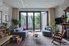 Modern home with Living Room, Pendant Lighting, Console Tables, Sofa, Rug Floor, Recessed Lighting, Chair, Ceiling Lighting, Wood Burning Fireplace, Standard Layout Fireplace, Light Hardwood Floor, and Coffee Tables. PARLOR FLOOR - LIVING ROOM (DOORS CLOSED)
Photo © Ashok Sinha Photo 10 of Bed-Stuy Townhouse