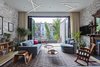 Modern home with Living Room, Pendant Lighting, Sofa, Ceiling Lighting, Light Hardwood Floor, Recessed Lighting, Console Tables, Chair, Wood Burning Fireplace, Coffee Tables, Standard Layout Fireplace, and Rug Floor. PARLOR FLOOR - LIVING ROOM (DOORS OPEN)
Photo © Ashok Sinha Photo 11 of Bed-Stuy Townhouse