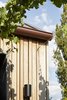 Modern home with Exterior, Metal Roof Material, House Building Type, Gable RoofLine, and Wood Siding Material. Exterior detail Photo 6 of Coburg House