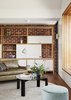 Modern home with Living Room, Lamps, Shelves, Sofa, Ceiling Lighting, Bench, Media Cabinet, Coffee Tables, Storage, Wall Lighting, and Medium Hardwood Floor. Living Area Photo 7 of Coburg House
