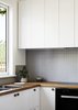 Modern home with Kitchen, Medium Hardwood Floor, Wall Oven, Wood Cabinet, Range Hood, White Cabinet, Ceiling Lighting, Wood Counter, Drop In Sink, Cooktops, Ceramic Tile Backsplashe, and Wall Lighting. Kitchen Photo 9 of Coburg House