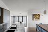 Modern home with Kitchen, Wall Oven, Quartzite Counter, Wood Cabinet, Dishwasher, Range Hood, Undermount Sink, Stone Slab Backsplashe, Ceiling Lighting, Wall Lighting, Pendant Lighting, Light Hardwood Floor, Refrigerator, Colorful Cabinet, and Cooktops. Kitchen & Meals area Photo 5 of Yeronga House