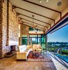 Modern home with Living Room, Coffee Tables, Sofa, Gas Burning Fireplace, and Ceiling Lighting. "Outdoor"/indoor living room with 26' wide bifold door system to make the space feel open when desired Photo 4 of Shifting Shores